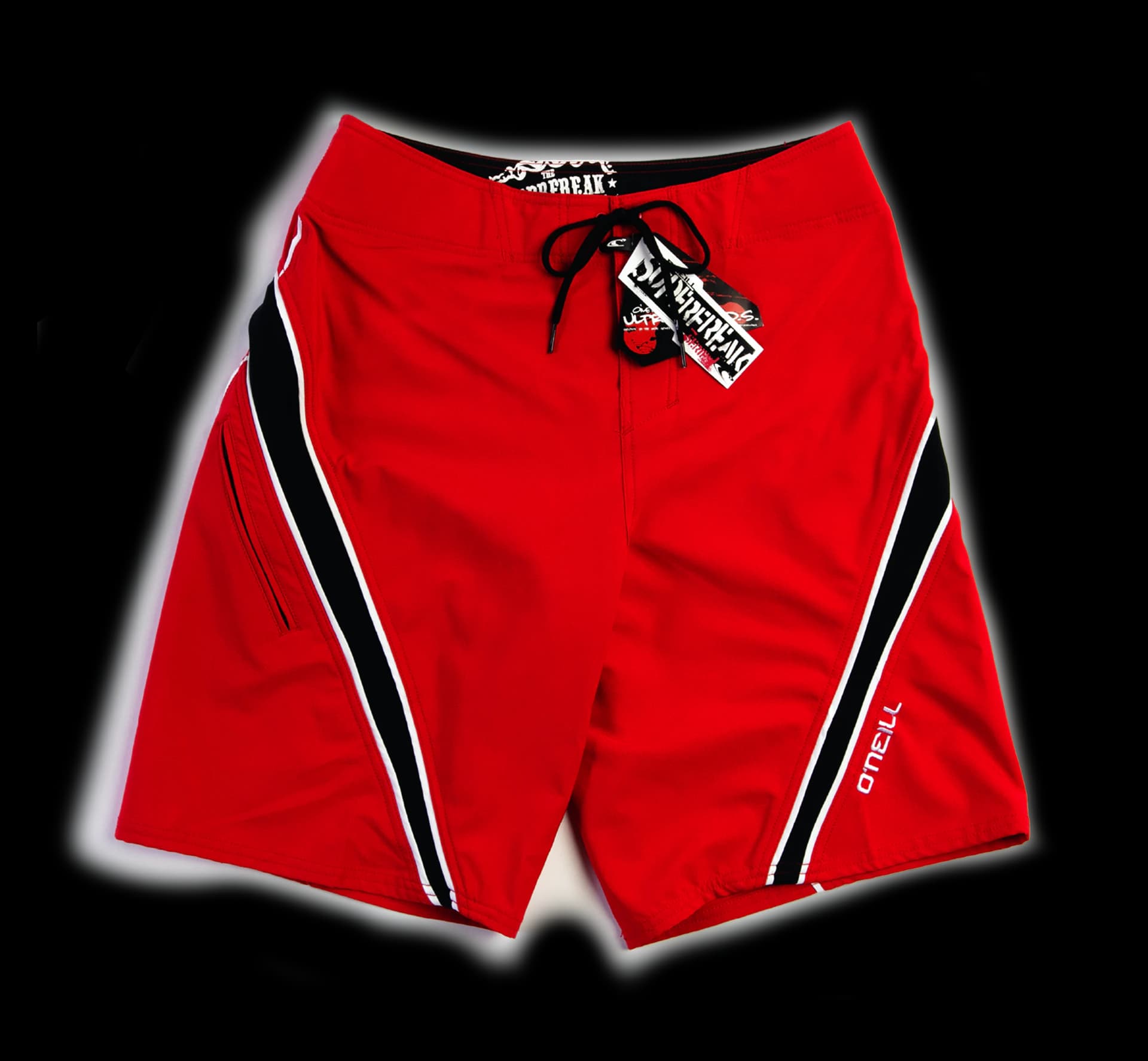 A red O'Neill boardshort with a black and white stripe running down each side, hangtags still attached at the drawstring.