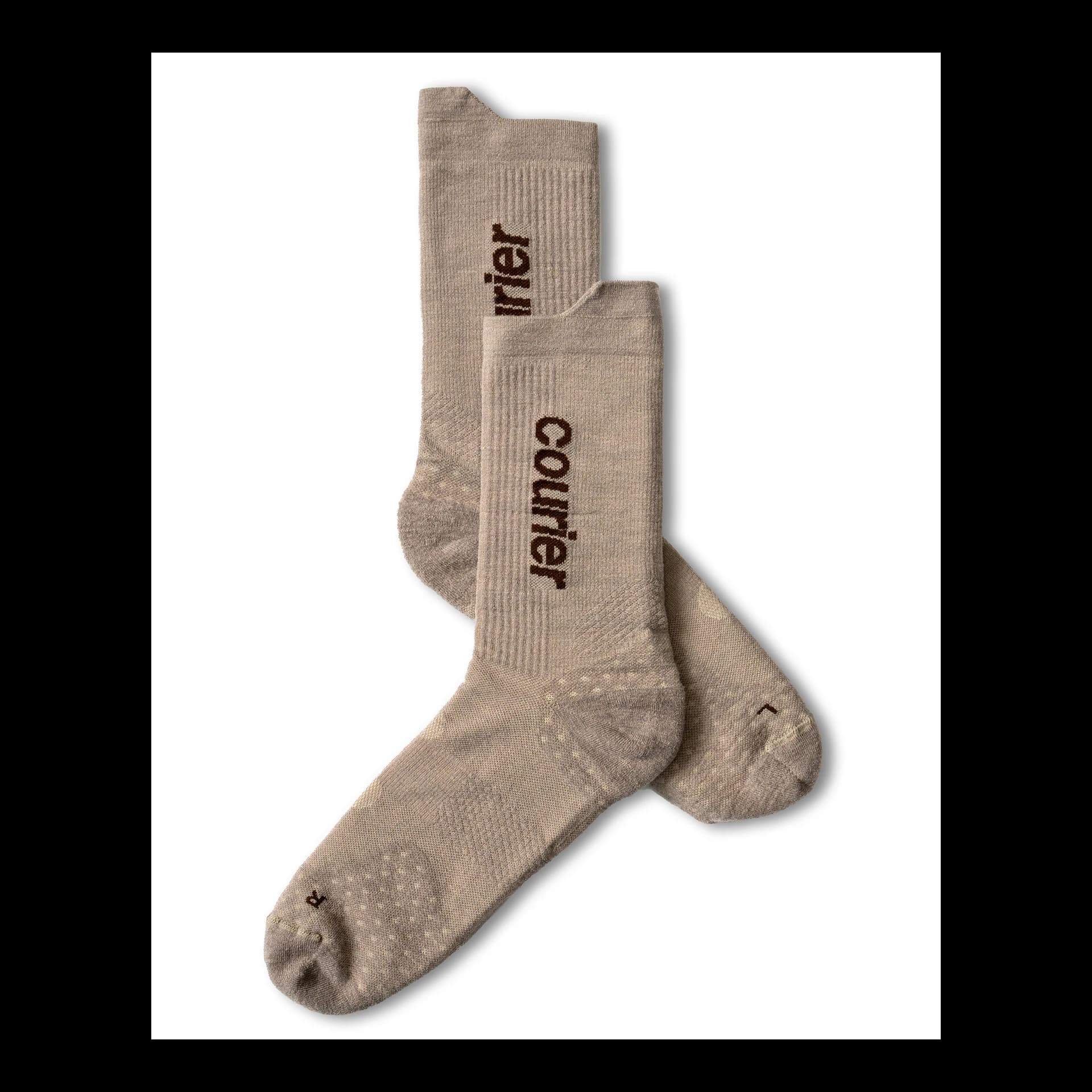 A pair of oatmeal crew socks with "courier" knitted in brown down the leg.