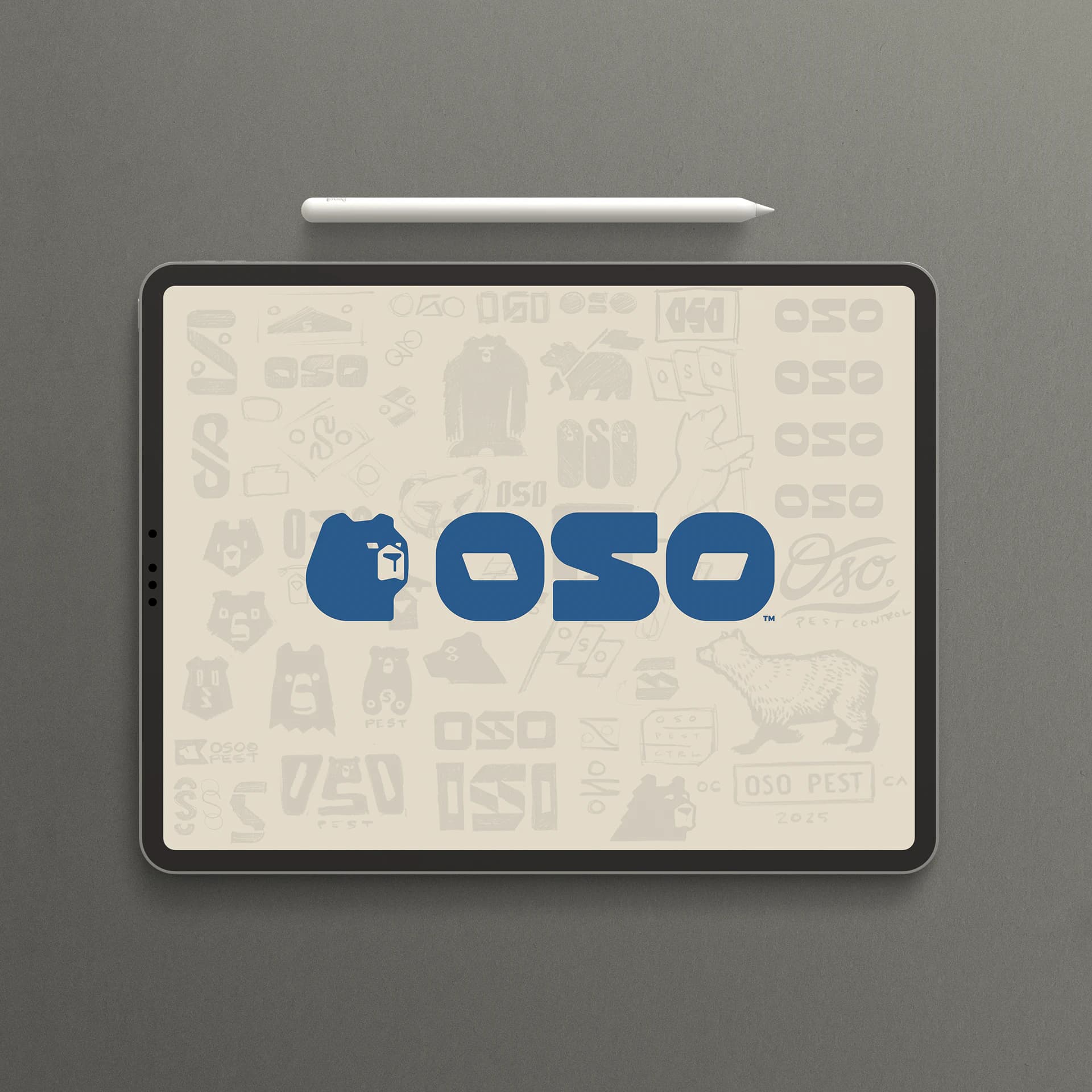 A tablet showing the finished Oso logo in blue over faded pages of early sketches and wordmark studies.