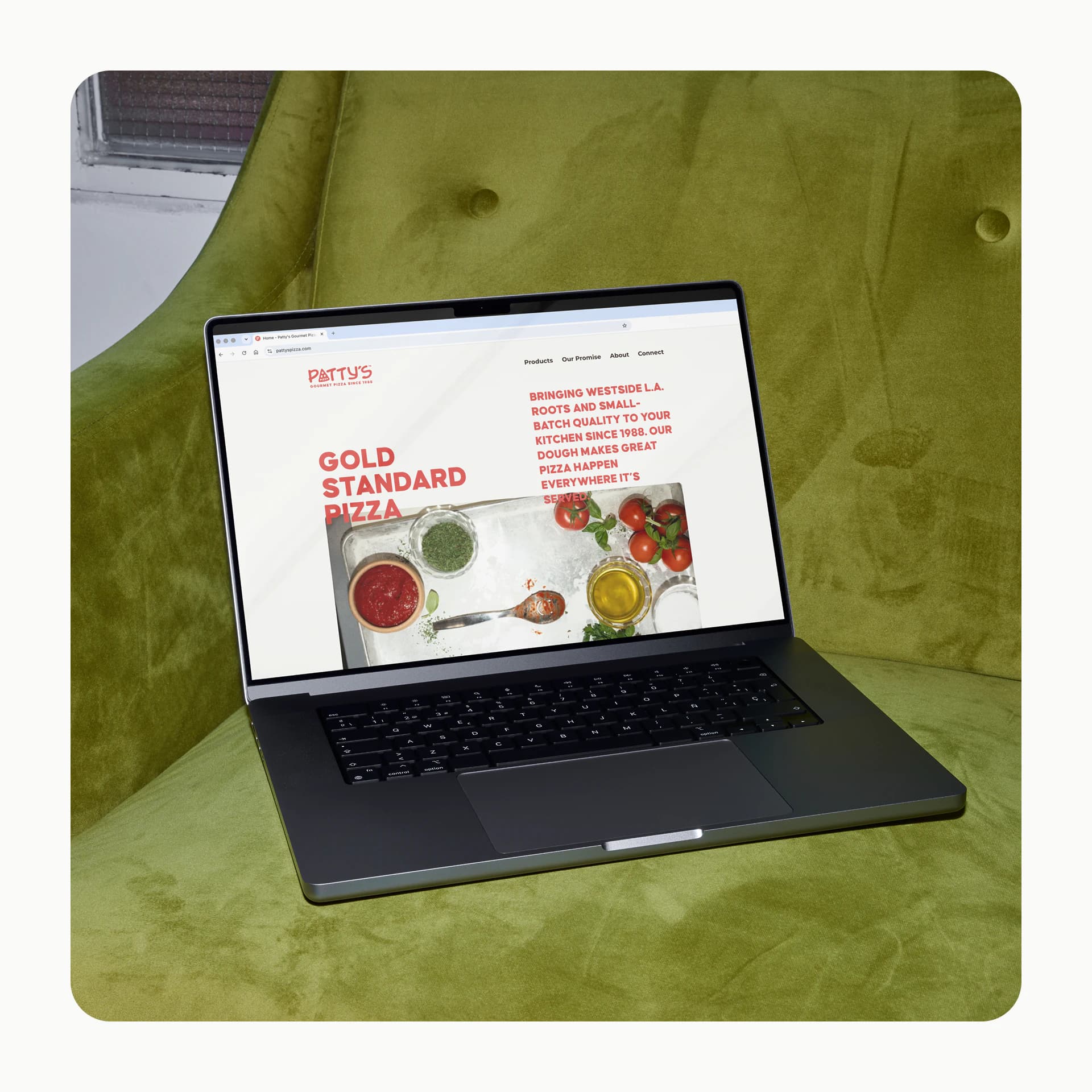 A laptop on a green velvet armchair showing the Patty's website, headed "Gold Standard Pizza".